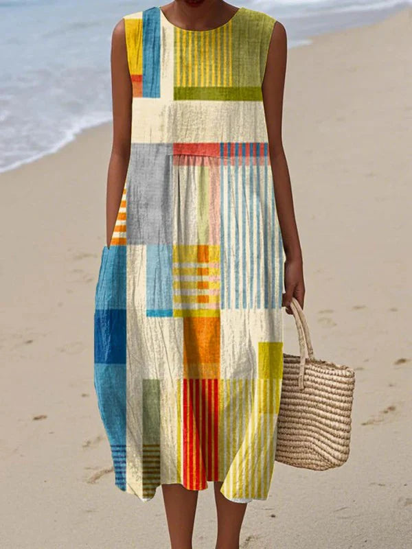 Women's Summer Dress with Sleeveless Design featuring vibrant patchwork print in yellow, blue, orange, and cream tones with relaxed midi silhouette