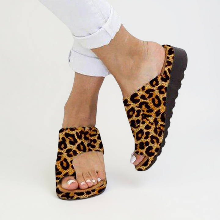 Women's toe split sandals in black featuring textured sole and adjustable strap placement for secure fit