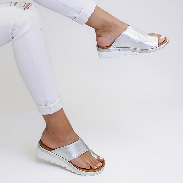 Overhead shot of black toe split sandals with grooved tread pattern and natural foot contour support