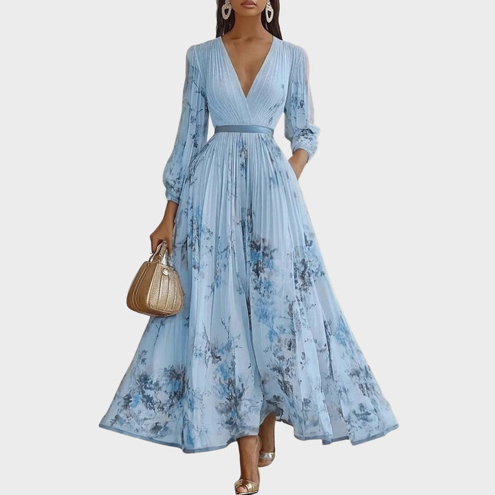 Elegant Pleated Maxi Dress in light blue with V-neck and floral print worn by model