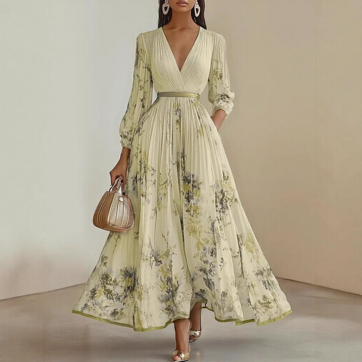 Model wearing Elegant Pleated Maxi Dress in white with delicate floral print throughout