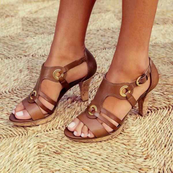 Close-up view of open toe heeled sandals featuring adjustable ankle strap and smooth finish