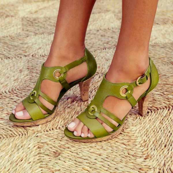 Detail shot of metal accent hardware on elegant heeled sandals with secure buckle fastening