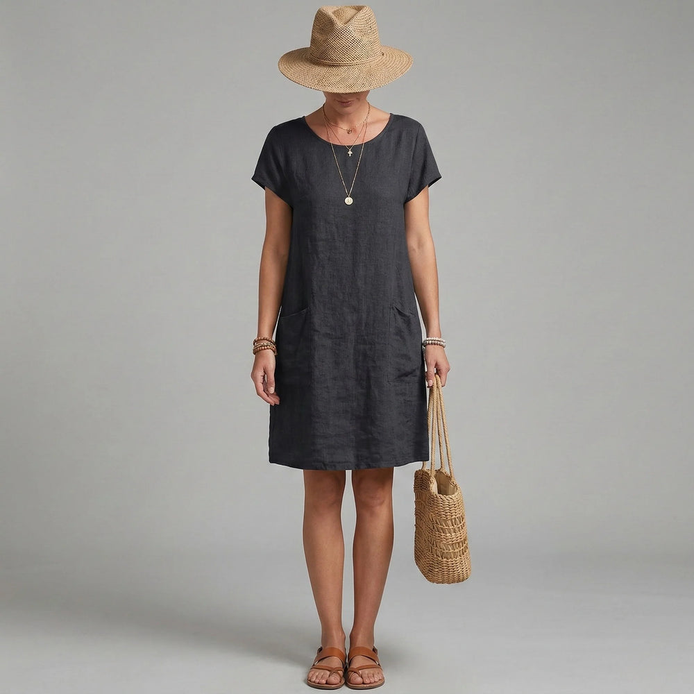 Close-up view of short sleeves and pockets dress showing round neckline and functional side pockets