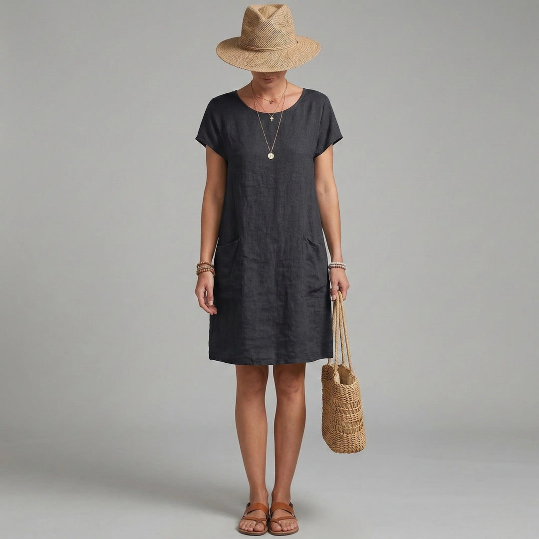 Close-up view of short sleeves and pockets dress showing round neckline and functional side pockets