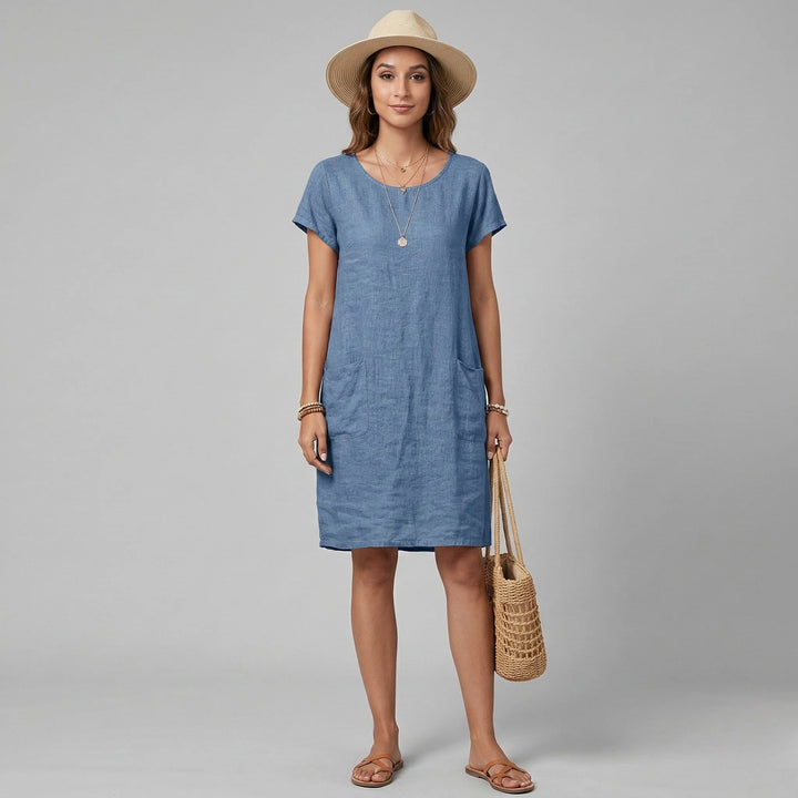 Full-length shot of casual shift dress with short sleeves paired with straw sun hat