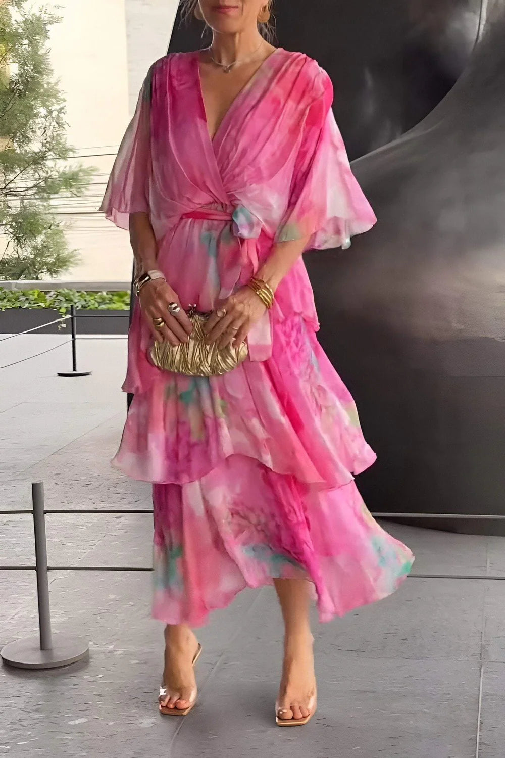 Side view of flowing tiered maxi dress with sheer chiffon layers and three-quarter sleeves
