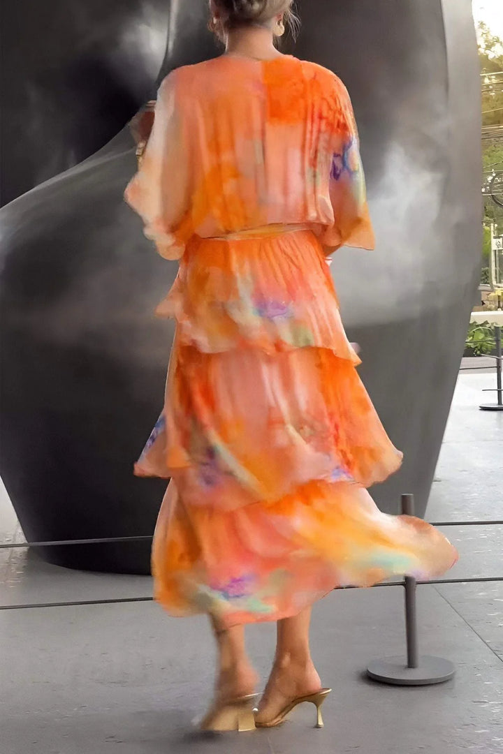 Back view of flowing maxi dress showing tiered construction and bohemian print placement