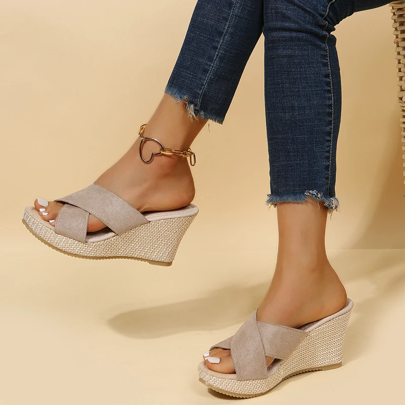 Side view of women's wedge sandals showing contoured footbed and woven platform heel detail