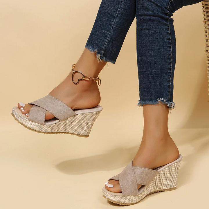 Side view of women's wedge sandals showing contoured footbed and woven platform heel detail