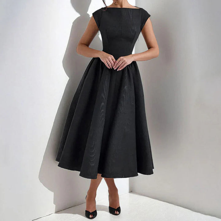 Side view of cap sleeve midi dress showing fitted bodice and full skirt silhouette