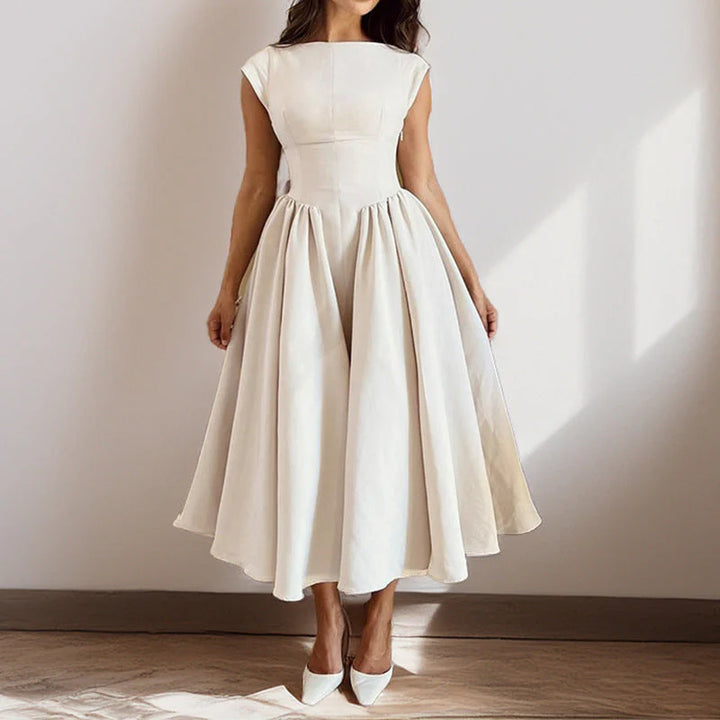 Detail of round neckline and cap sleeves on fit and flare midi dress