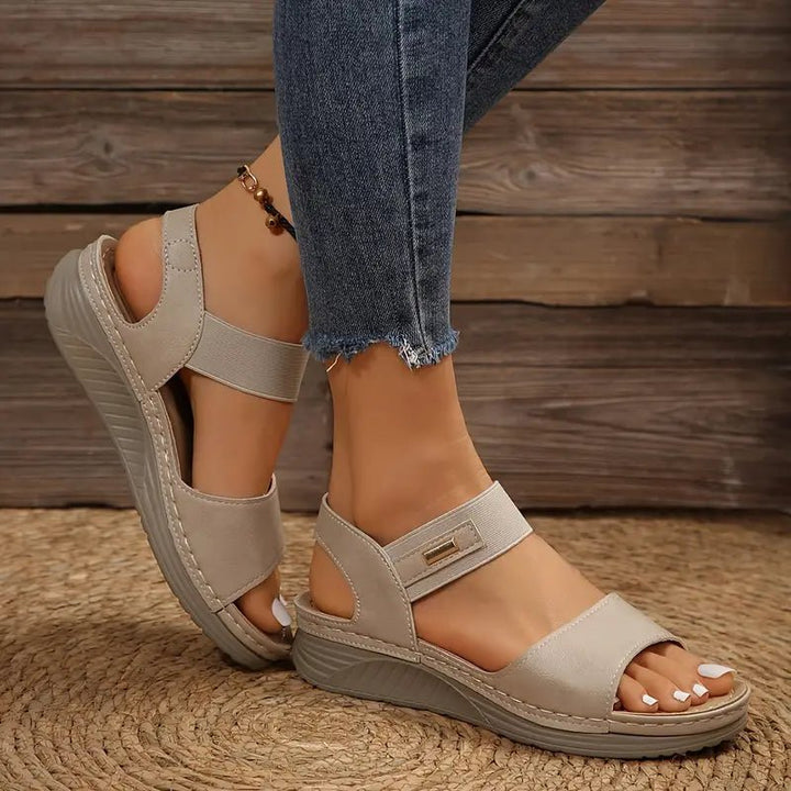 Women's orthopedic sandals in brown worn with casual outfit, showcasing open-toe design and adjustable fit for all-day comfort support