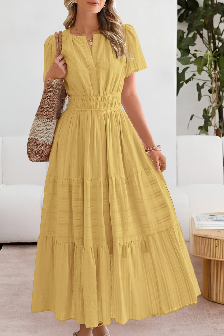 Genevieve models the Boho Breeze Midi Dress in soft yellow with tiered skirt and elasticated waist