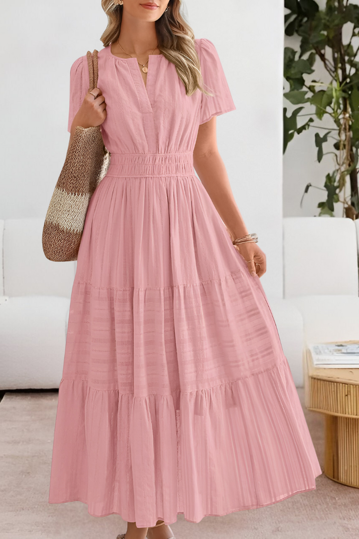 Back view showing the graceful drape and tiered construction of the midi dress