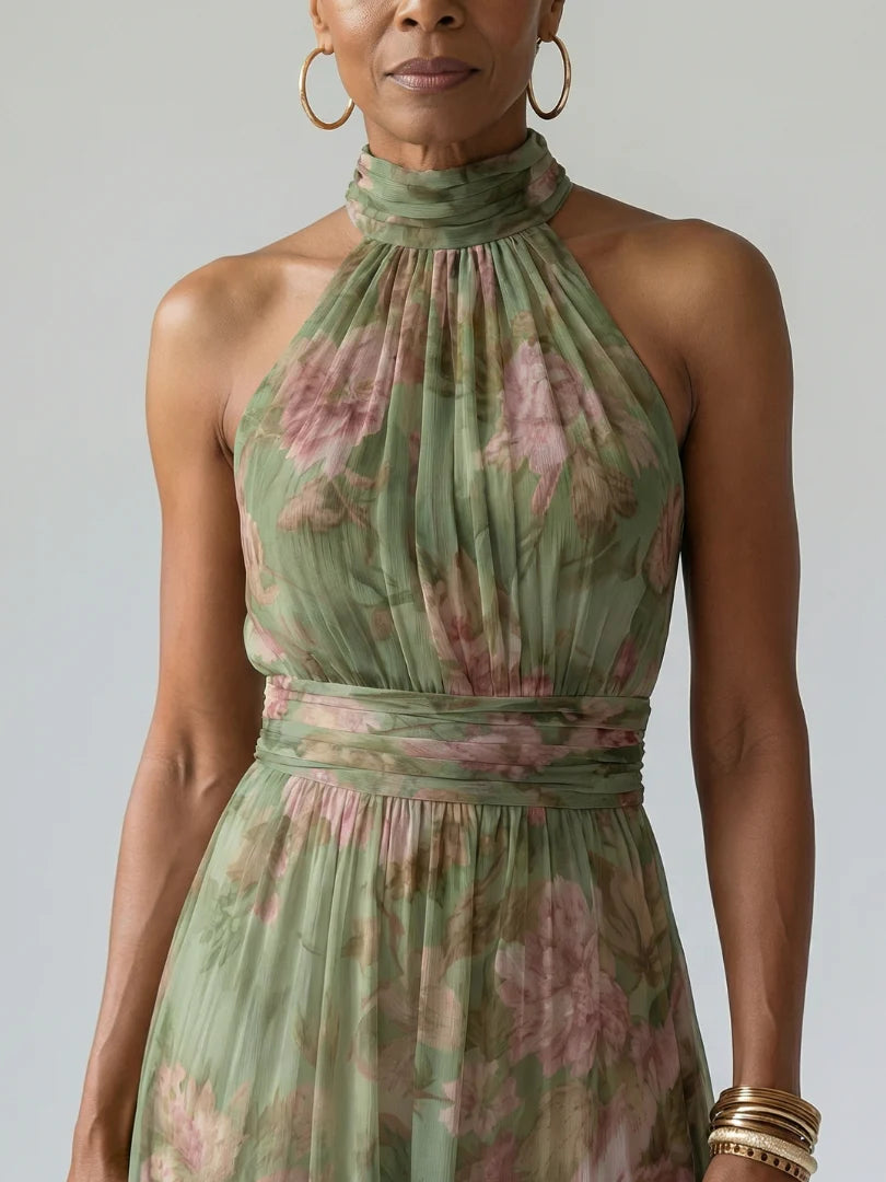 Side profile of midi dress with defined waist and sheer floral overlay in sage green