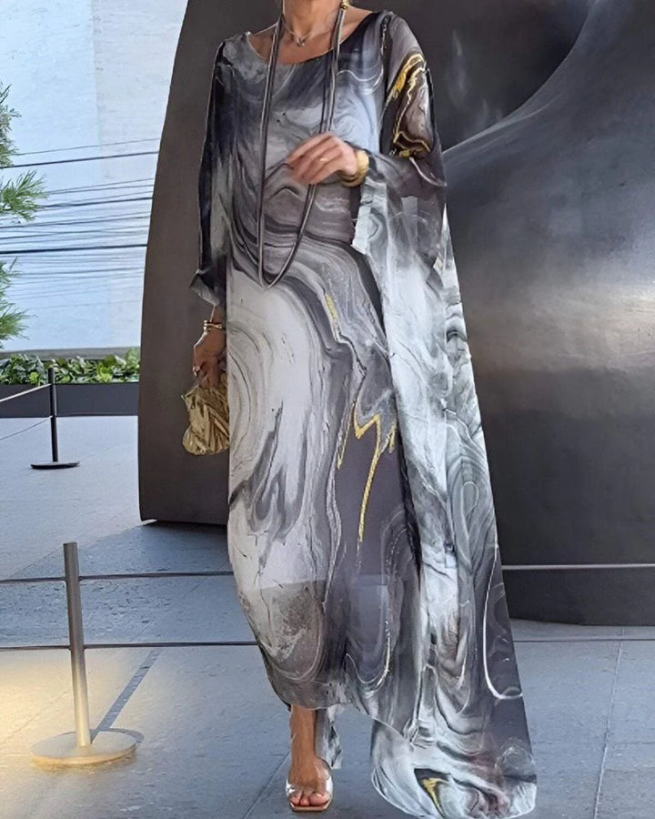 Side angle of oversized marble print maxi dress showing batwing sleeve drape