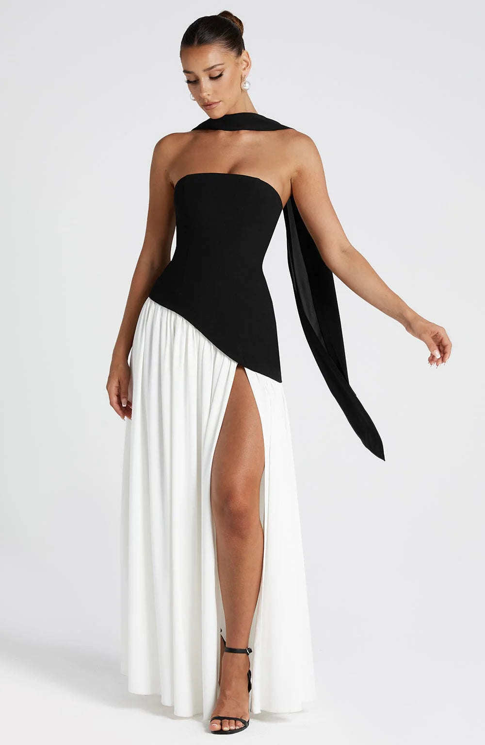 Close-up view of the structured strapless bodice and asymmetric waistline detail on the maxi dress