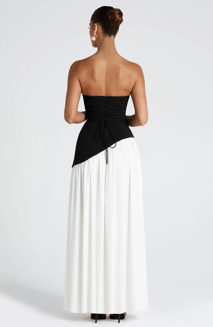 Side angle showing the high front slit and flowing drape of the Strapless Maxi Dress