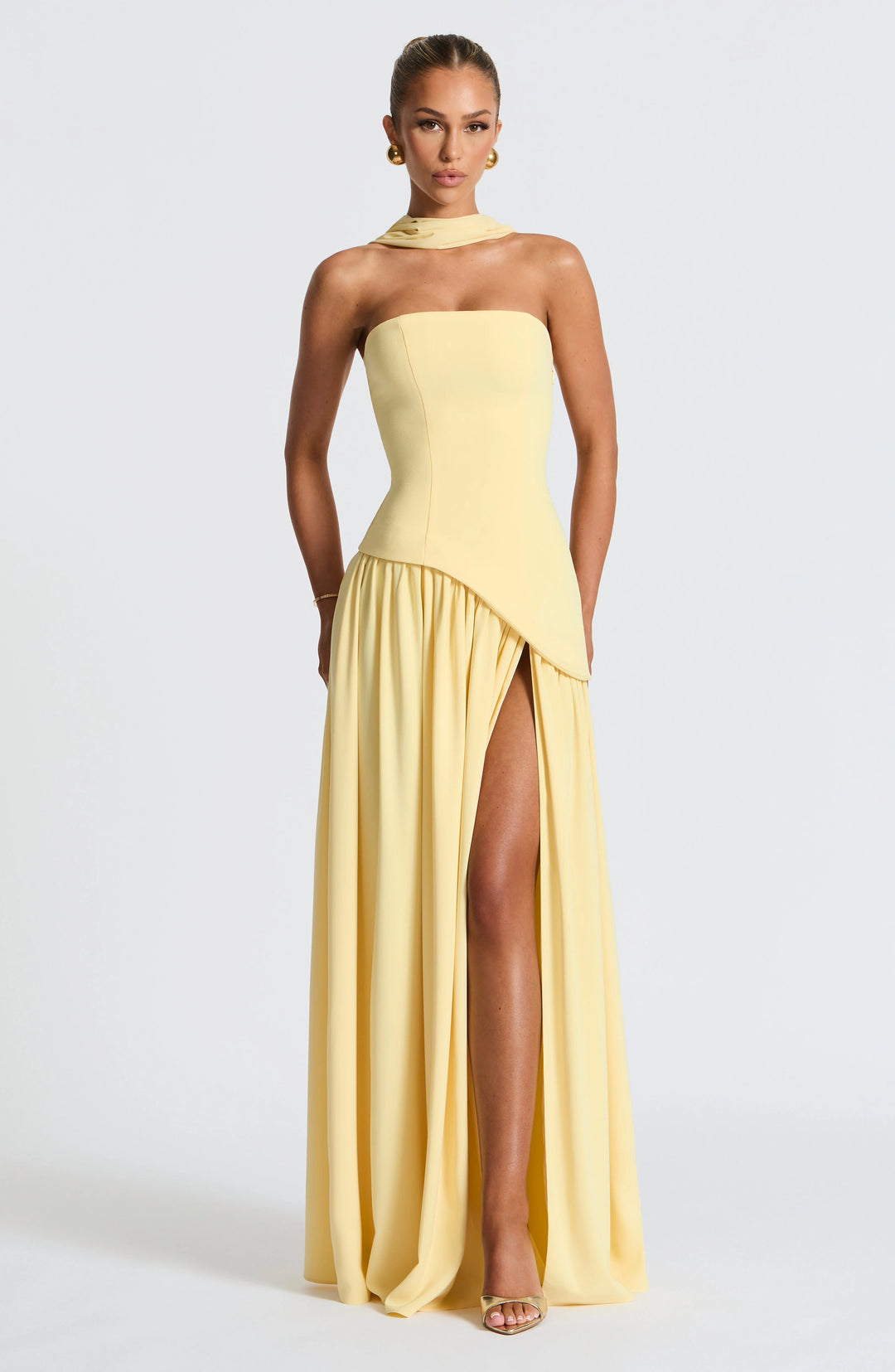Model wearing the Strapless Maxi Dress with High Slit paired with heeled sandals