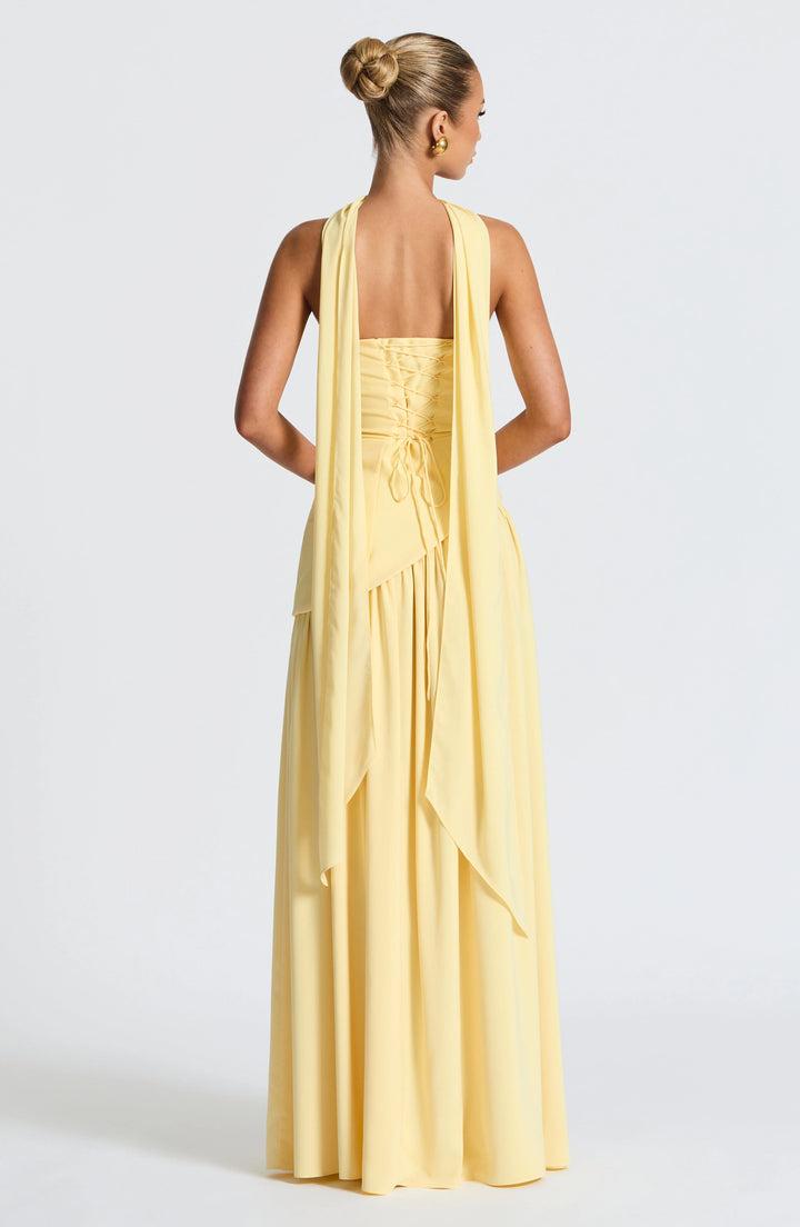 Movement shot showing the high slit and drape of the full-length skirt
