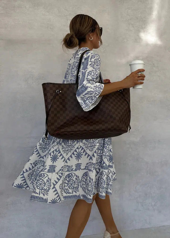 Full-length view of Women's Boho Patterned Long Sleeve Mini Dress styled with woven bag for casual summer wear