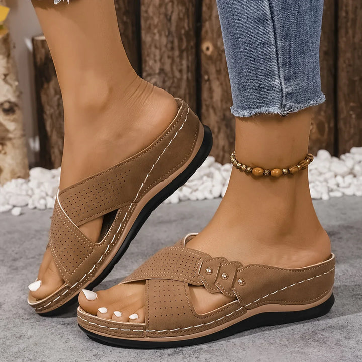 Women's orthopaedic wedge sandals in navy blue with white pebble background showing full design