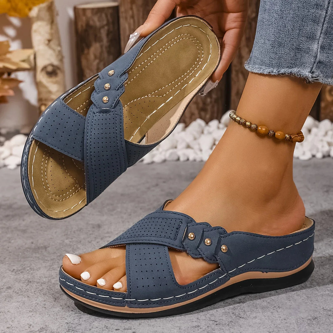 Top view of orthopaedic wedge sandals showing perforated cross-strap detail and buckle closure