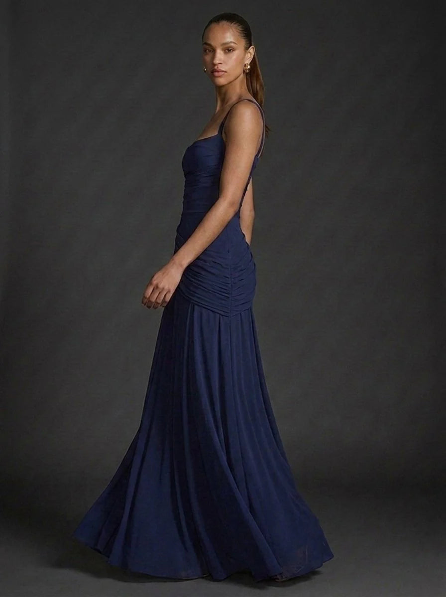 Full-length view of butter yellow maxi dress with flared hem and elegant silhouette