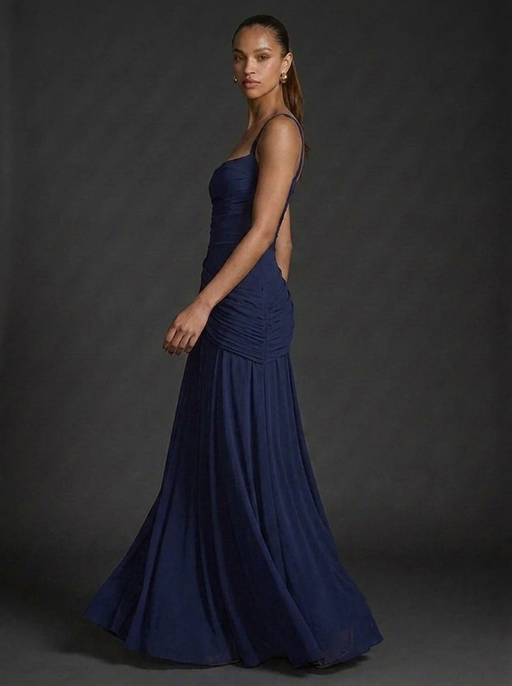 Full-length view of butter yellow maxi dress with flared hem and elegant silhouette