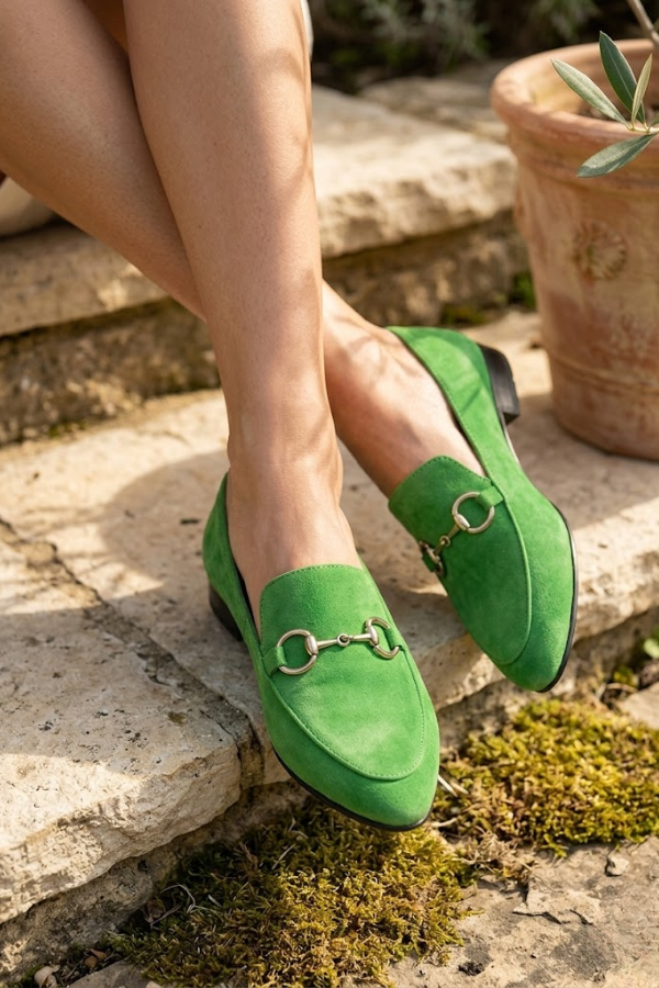 Close-up view of green canvas moccasins showing bohemian print and slip-on design for easy wear