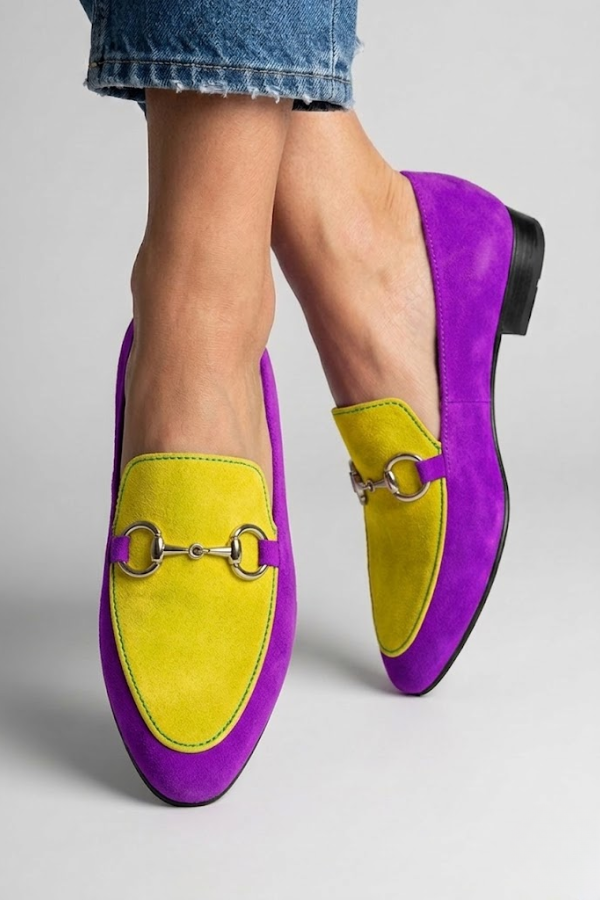 Detail shot of canvas upper and gold hardware on women's slip-on moccasins with bohemian styling