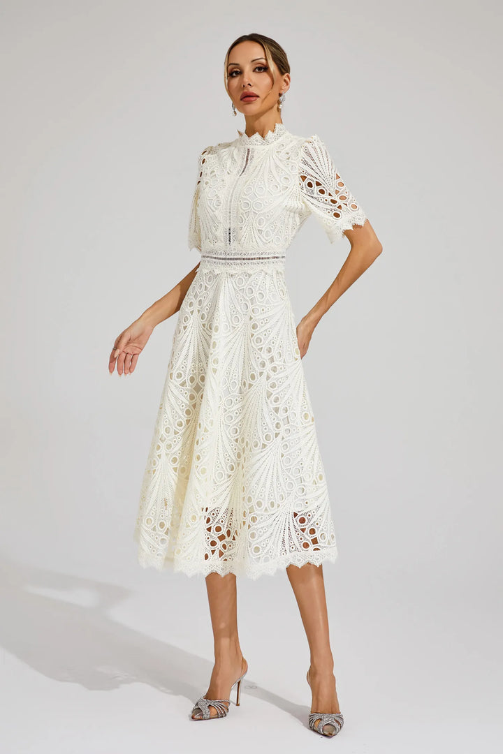 Detail of intricate crochet pattern and scalloped hemline on midi-length skirt