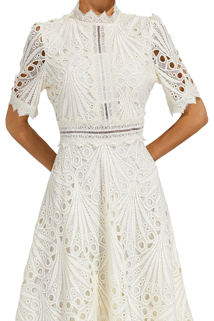Crochet midi dress styled for garden party with heeled sandals and statement earrings