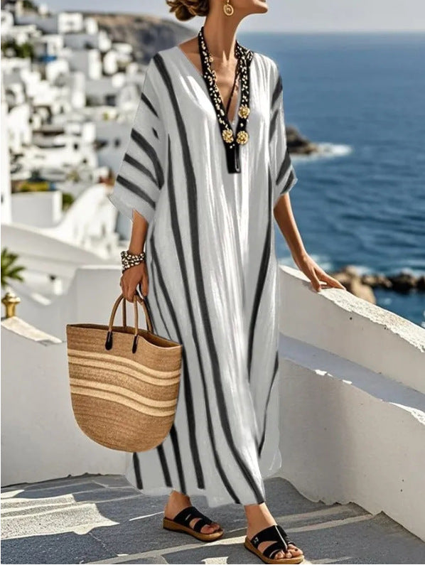 Detail shot of kaftan dress neckline and sleeve construction showing kimono-style wide sleeve design