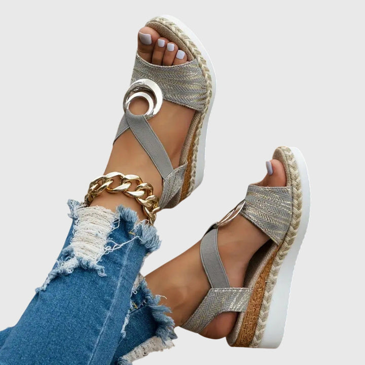 Close-up of textured fabric vamp straps and buckle closure on women's orthopedic sandals