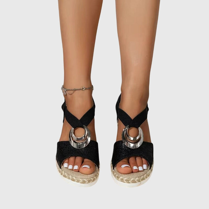 Three-quarter view of beige orthopedic buckle strap sandals with espadrille sole and supportive footbed
