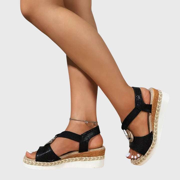 Women's orthopedic buckle strap sandals worn on both feet displaying open-toe design and platform height