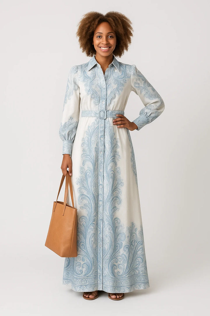 Flowing maxi dress with button fastening, long sleeves, and ornate blue paisley detailing throughout