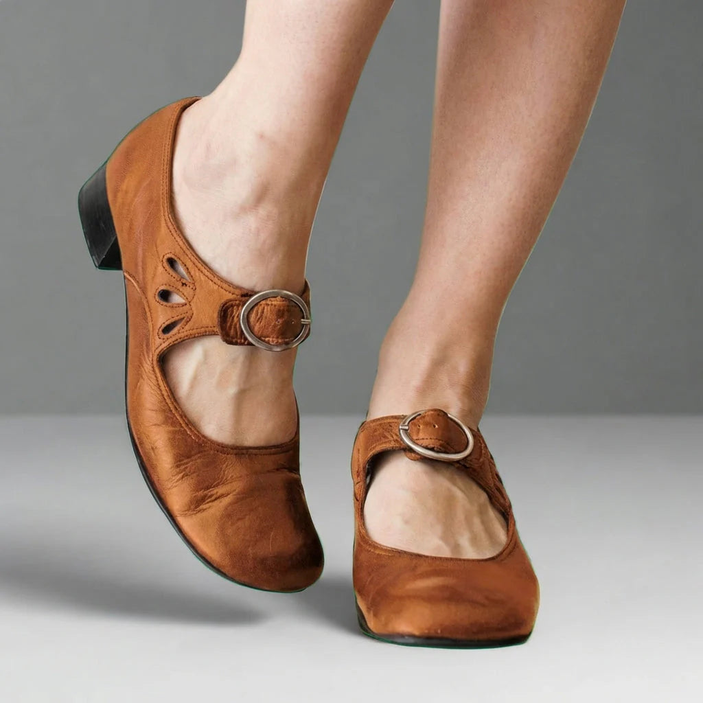 Close-up view of Mary Jane shoe rounded toe and circular buckle detail