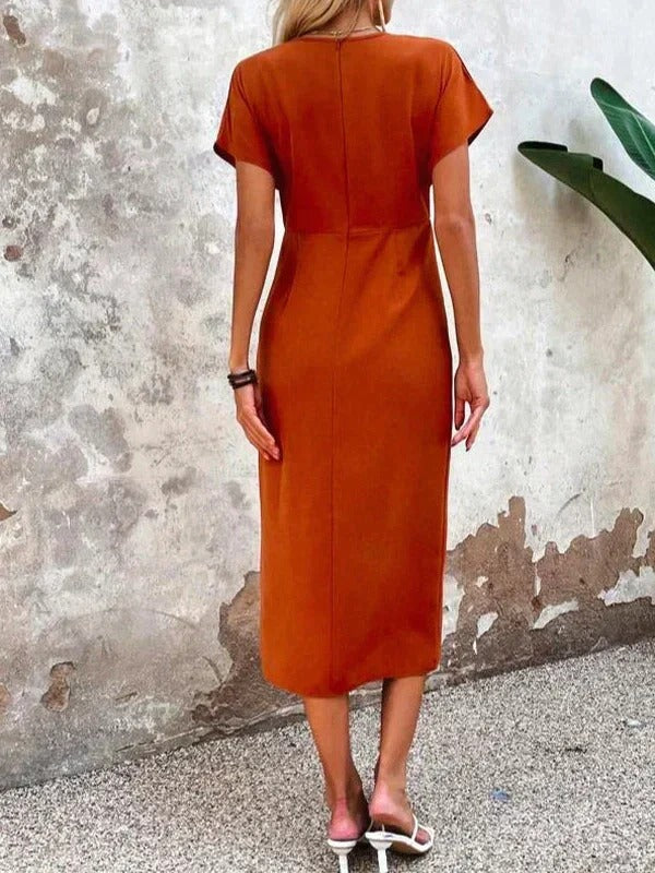 Full-length view of women's wrap midi dress styled for wedding guest occasions