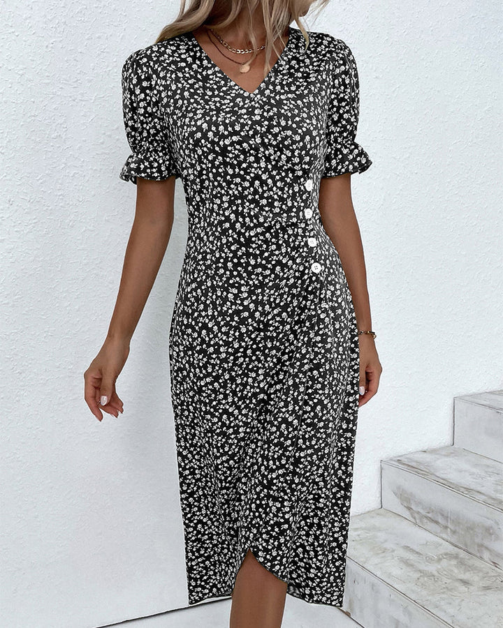 Green wrap dress featuring cream floral pattern, V-neckline and tailored silhouette for daywear