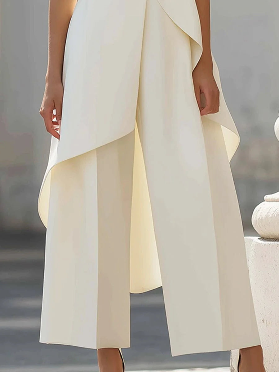 Close-up of asymmetric diagonal drape detail on sleeveless high-neck top