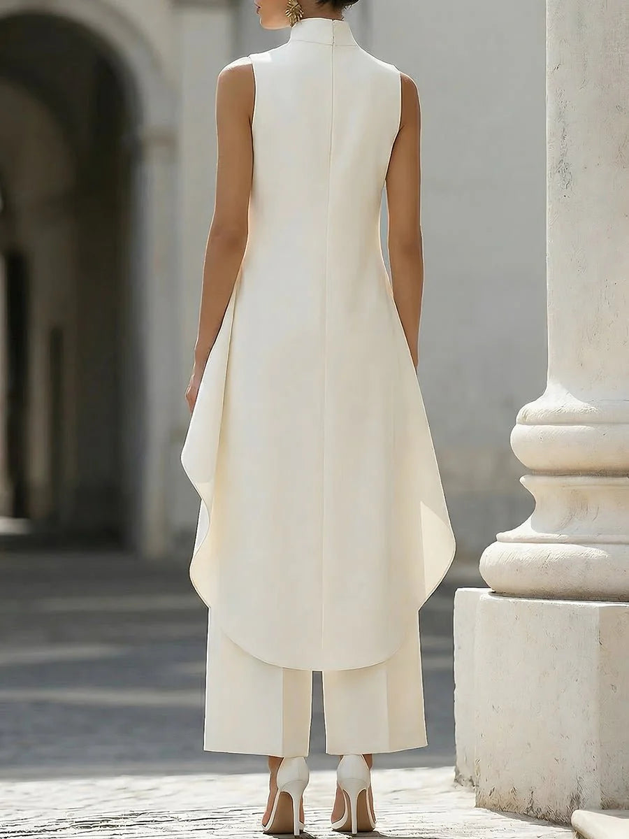 Side view showing sculptural movement of asymmetric panel on two-piece trouser set