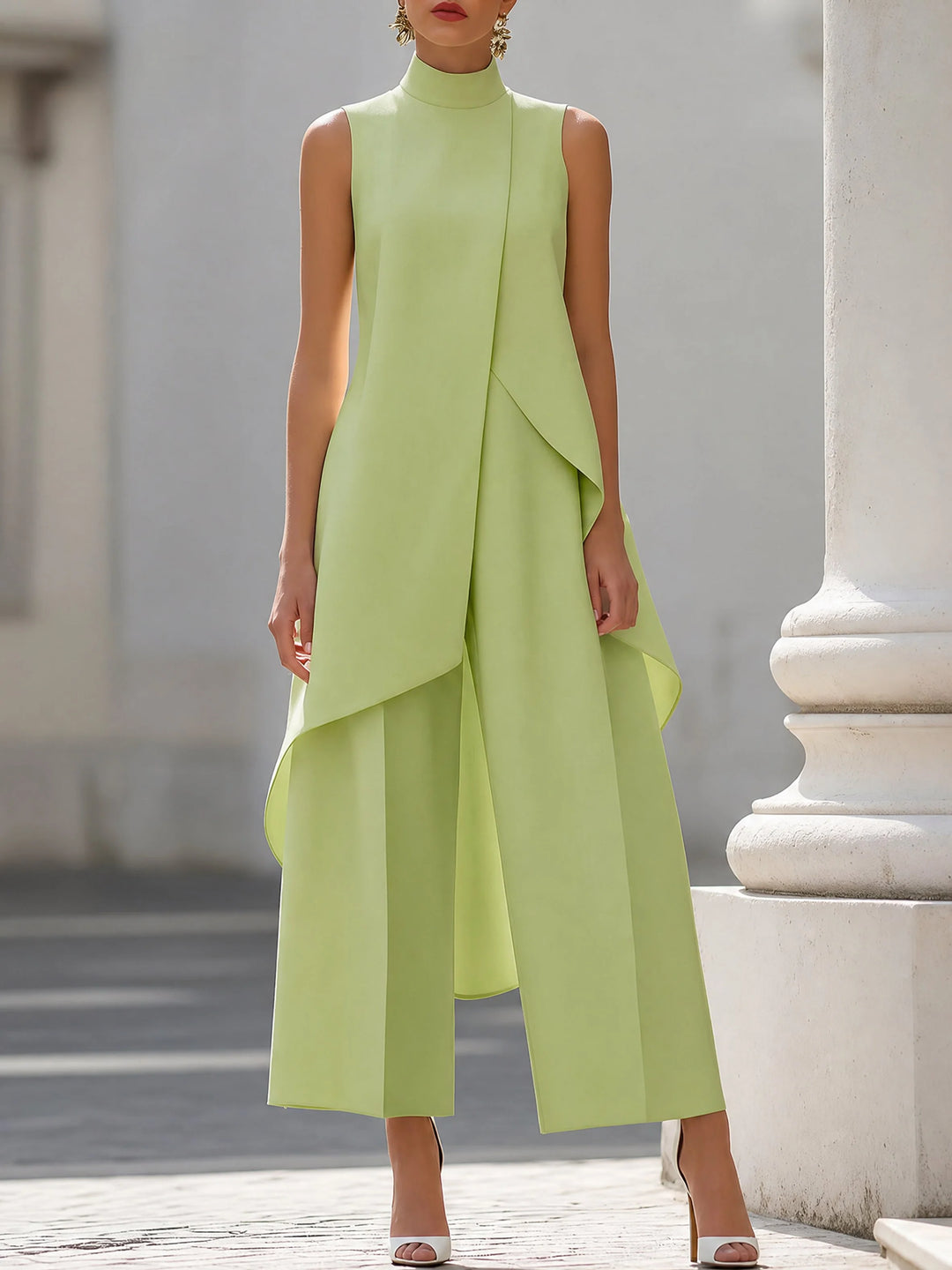 Model wearing cream two-piece suit with pointed-toe heels for formal occasion