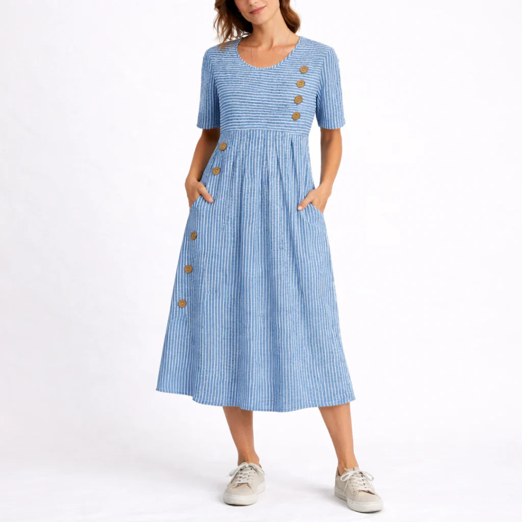 Woman wearing blue and white striped midi dress with button detail and short sleeves