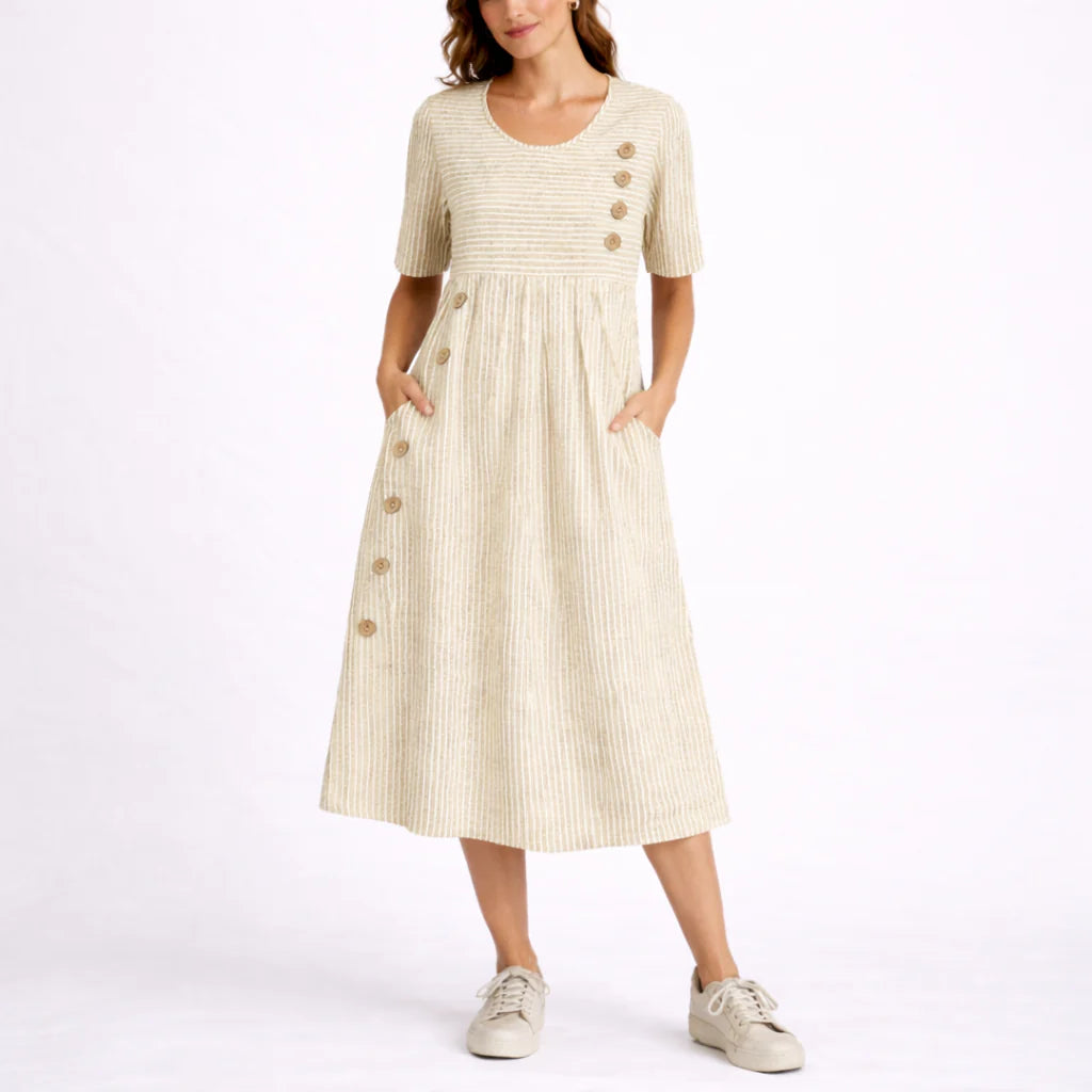 Side view of striped midi dress highlighting gathered skirt and in-seam pockets