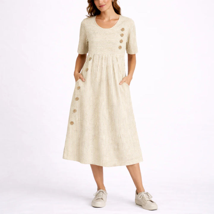 Side view of striped midi dress highlighting gathered skirt and in-seam pockets