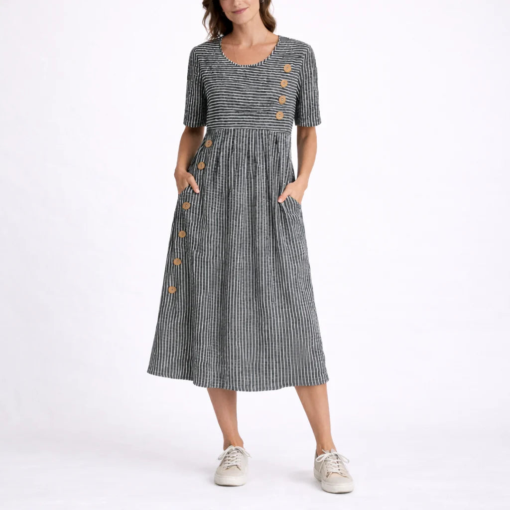 Full-length view of striped midi dress showing midi hemline and relaxed silhouette