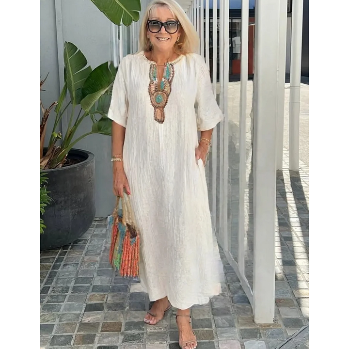 Woman wearing white Summer Maxi Dress with embroidered neckline and relaxed A-line silhouette for warm-weather occasions